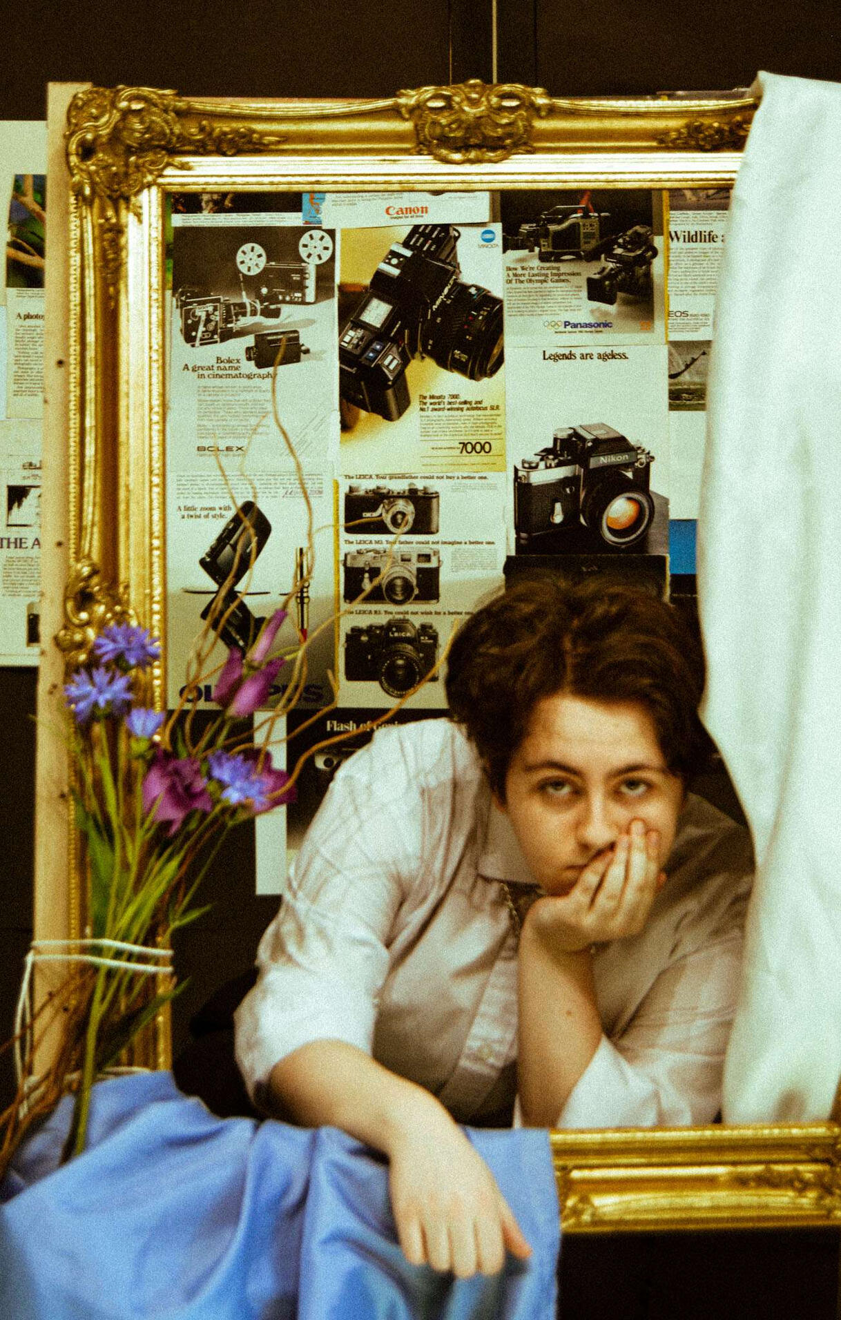 A picture of Mason, a white male, looking at the camera while smoke obscures the bottom half of his face. The entire photo is tinted blue-green.